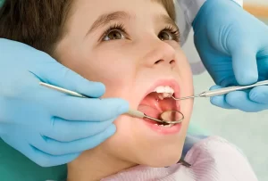 Pediatric dentist working ok kids teeth