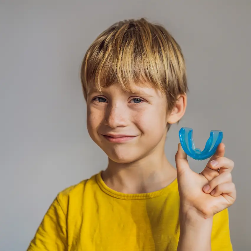 Kid holding night guard