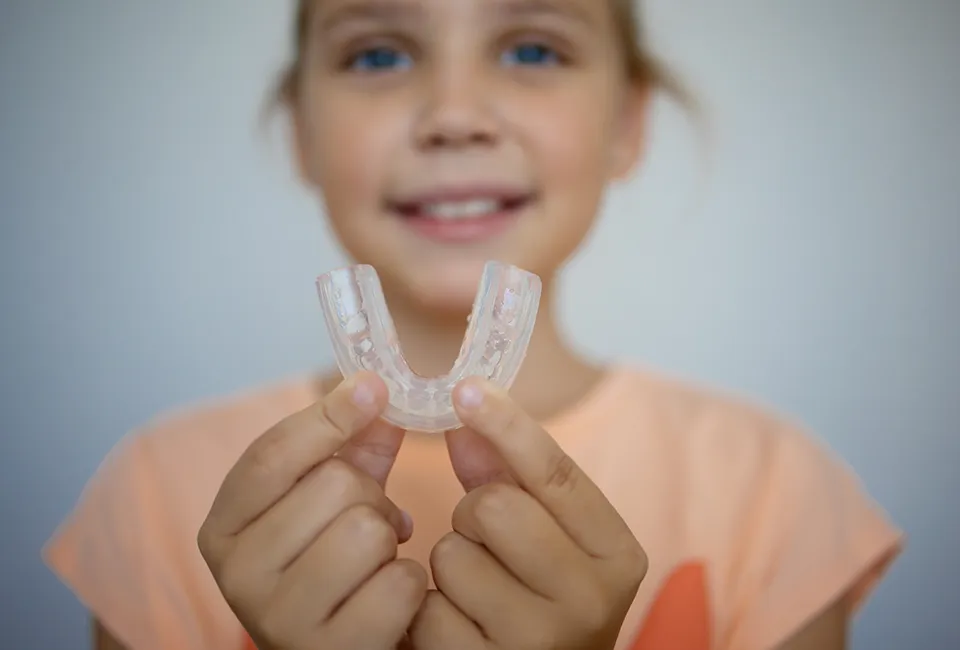 Patient holding mouth guard